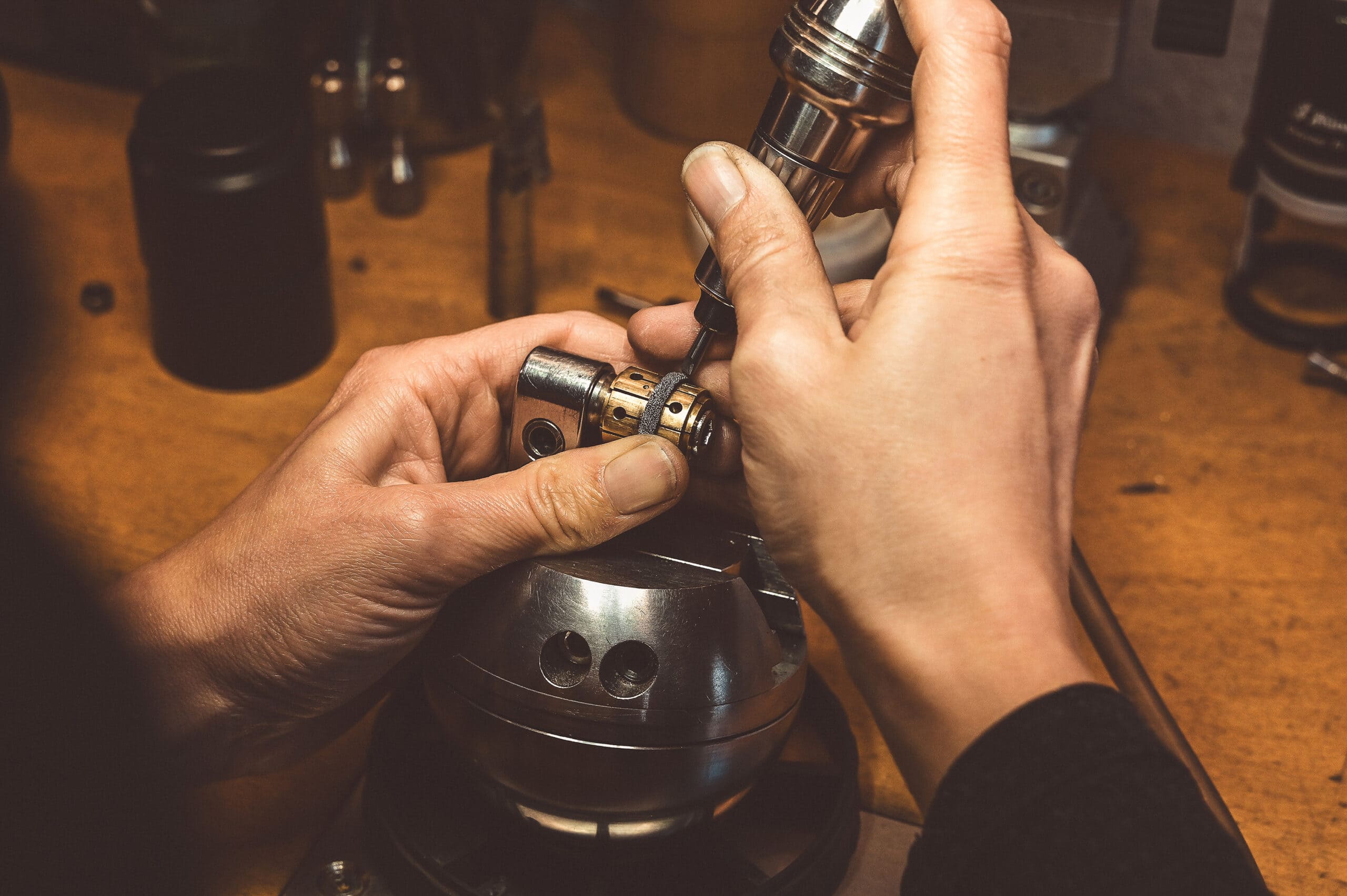 On the picture you see two hands working on a tantalum ring 